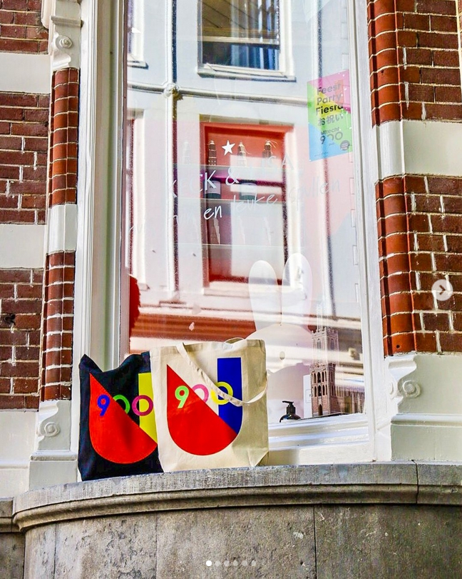 Twee tassen, een wit en een zwart met het logo van Utrecht 900 jaar.